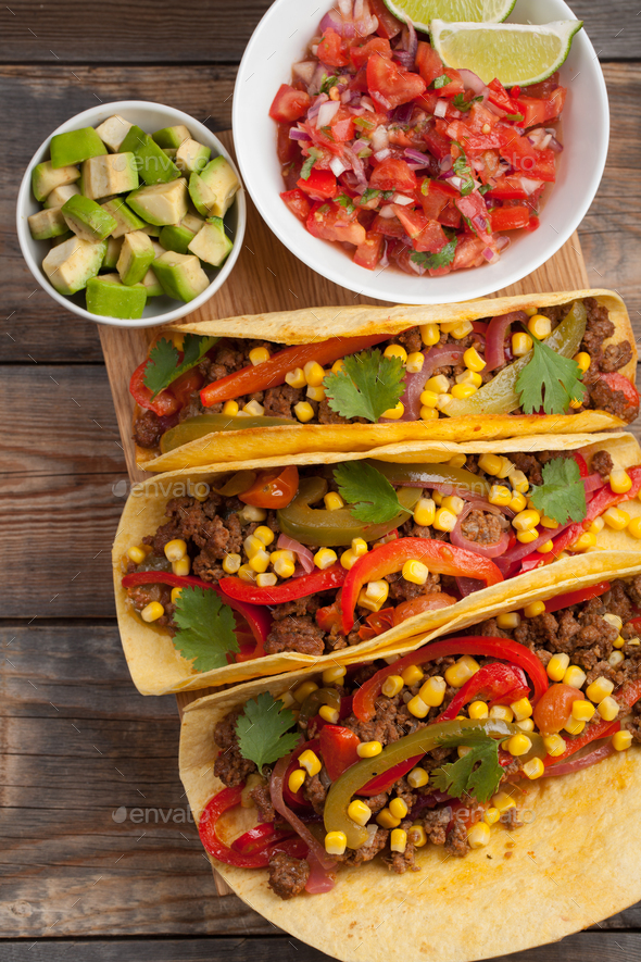 Mexican tacos with minced beef, vegetables and salsa. Tacos al pastor